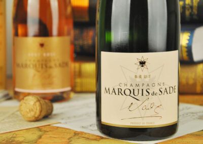 Marquis de Sade Brut Champagne bottle beside its cork